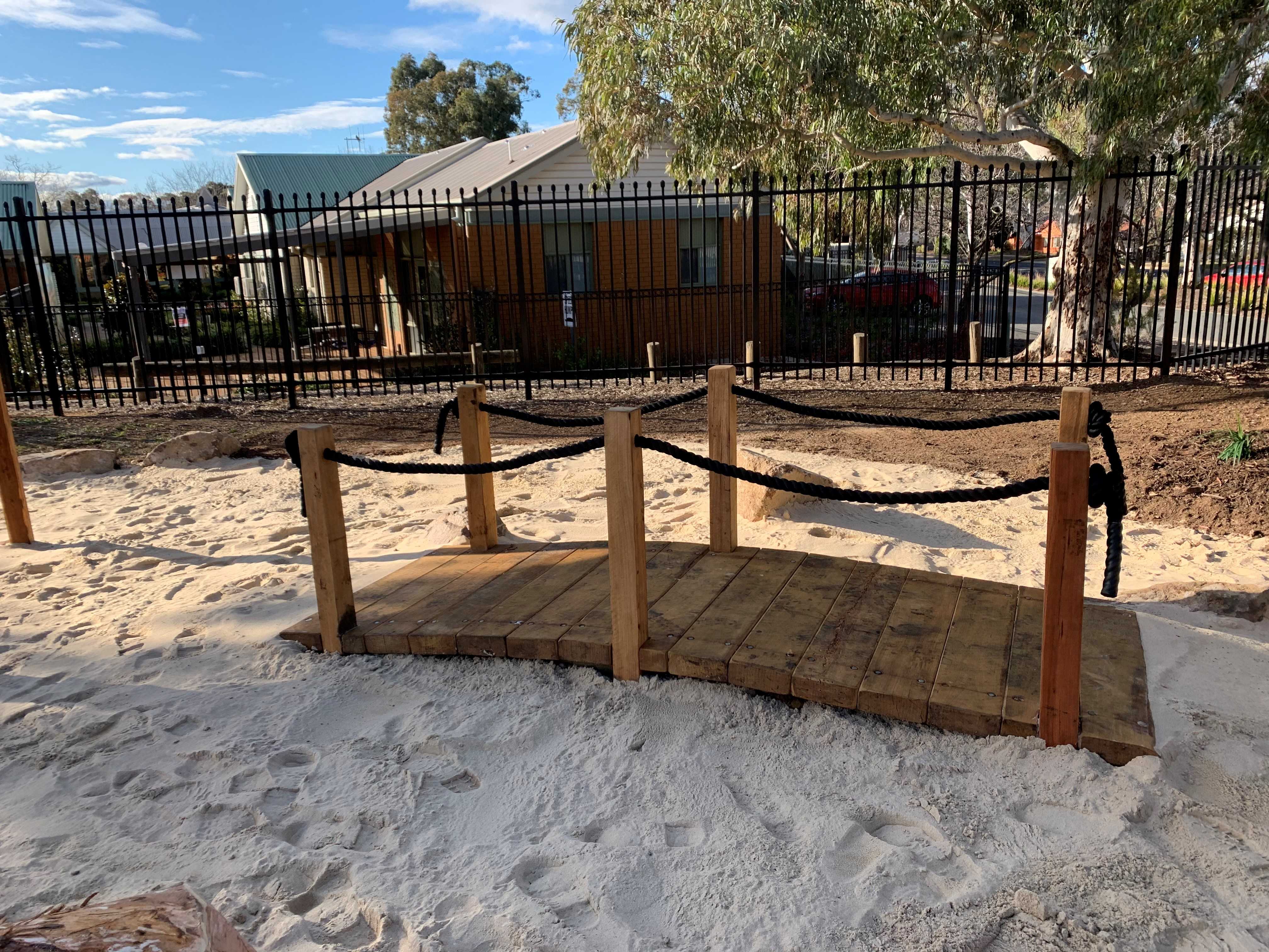 Sandpit with wooden bridge