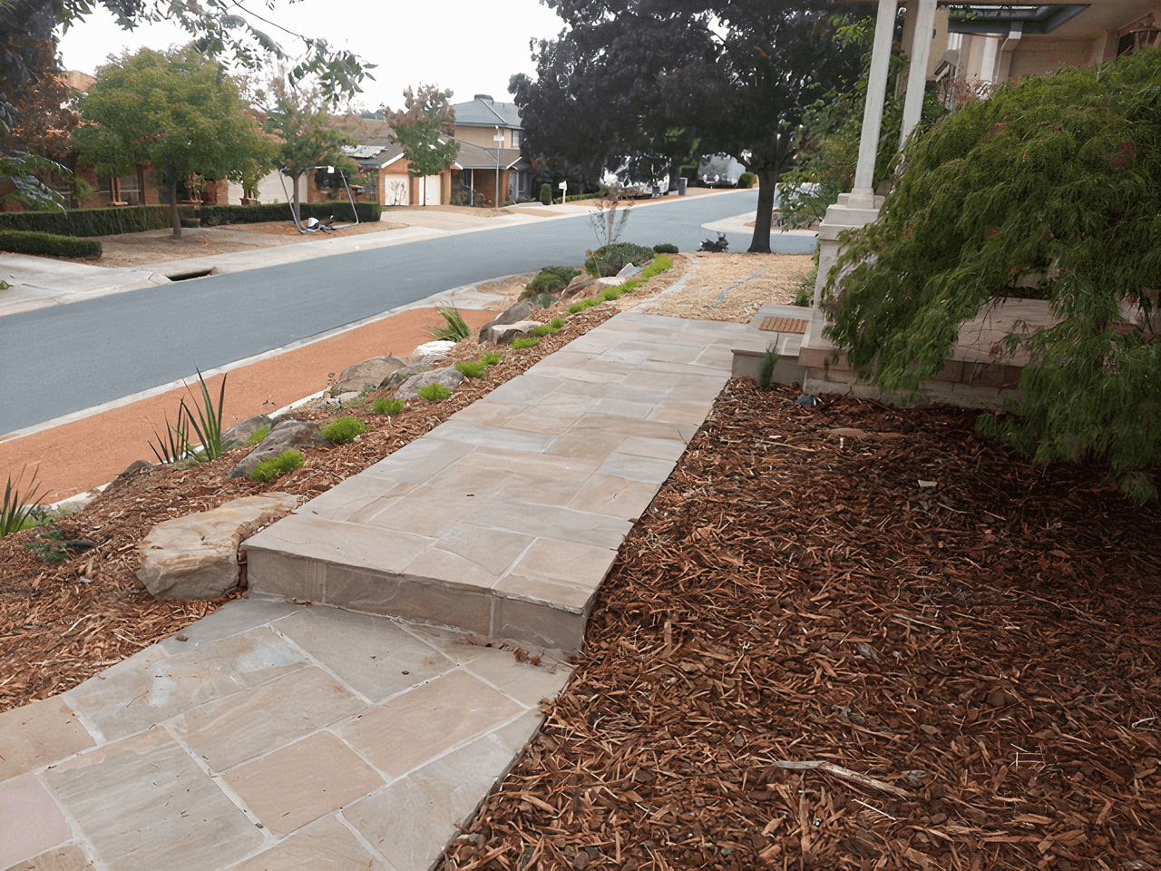 Stone paved pathway and mulched garden