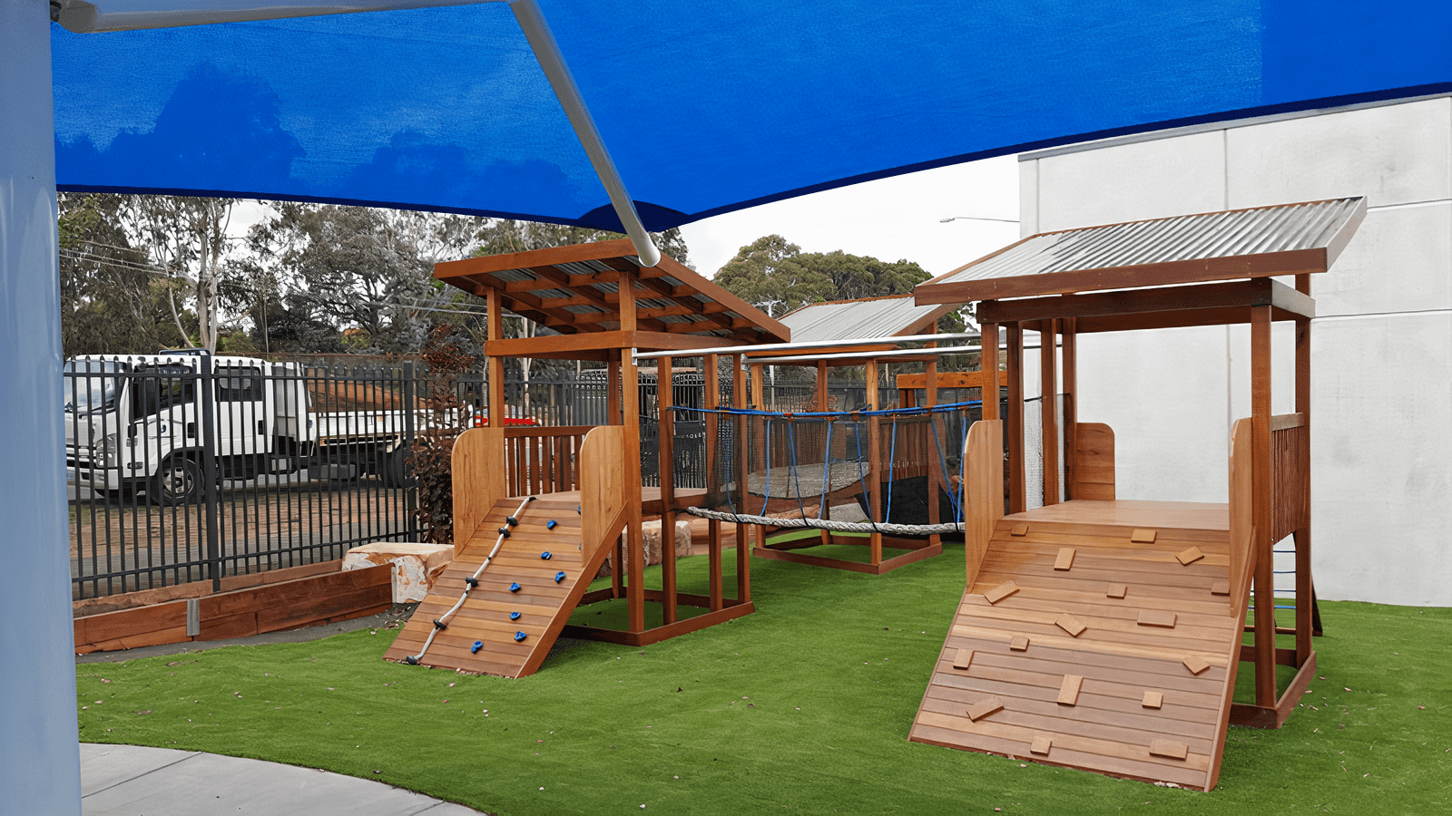 An adventure playground with a rope course and climbing wall